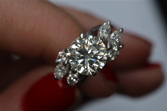 An 18ct white metal and single stone diamond ring, with marquise cut diamond set shoulders, size H/I.